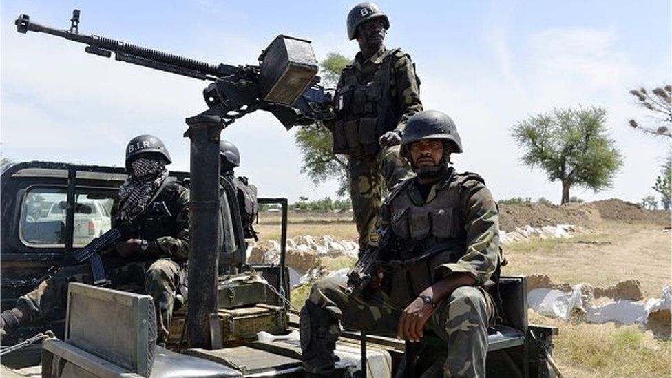 Cameroonian soldiers patrol on November 12, 2014 in Amchide, northern Cameroon, 1 km from Nigeria.