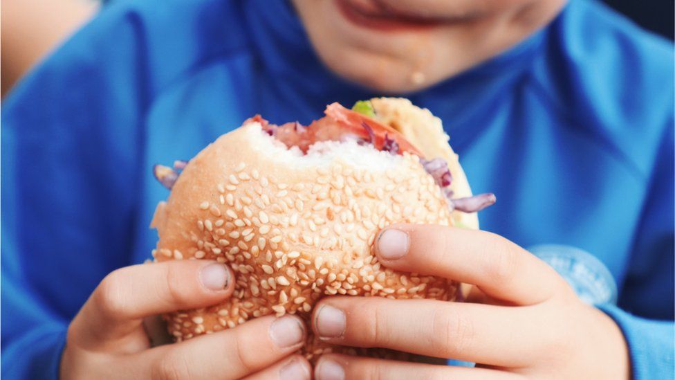 A child eating a burger