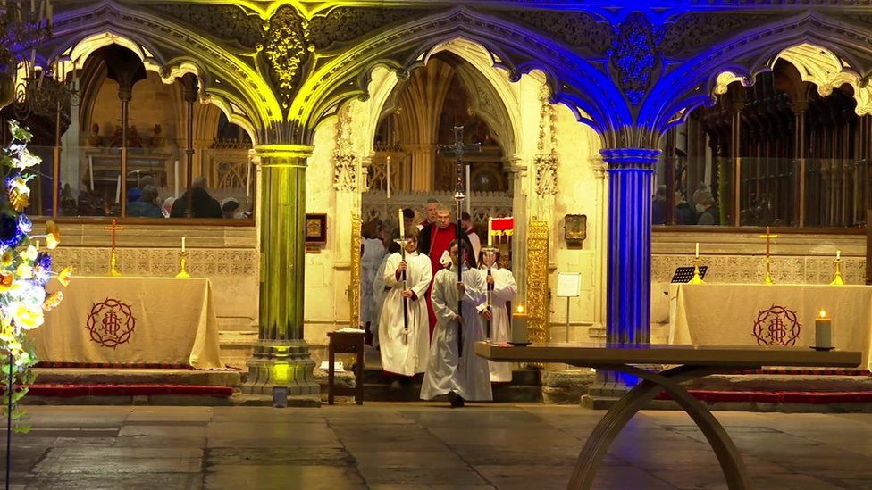 Shot inside the cathedral with candles and blue and yellow lights