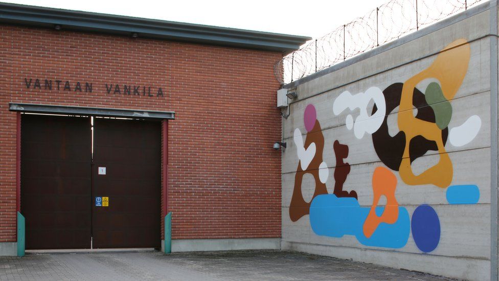 The entrance to the prison with a mural on one external wall