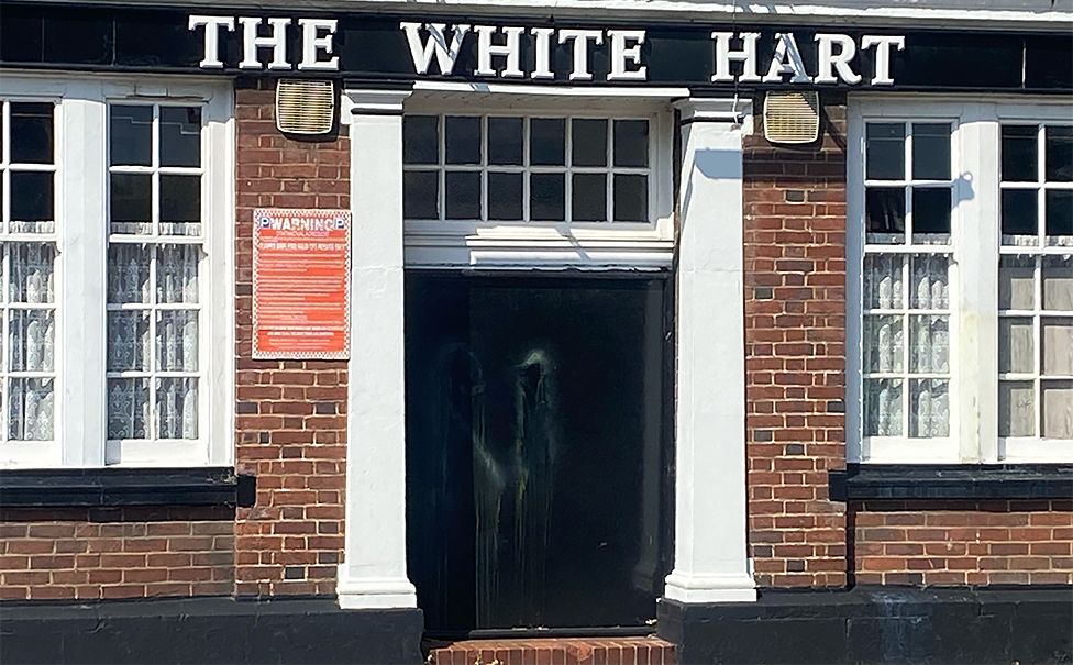Paint smears on door of White Hart Inn