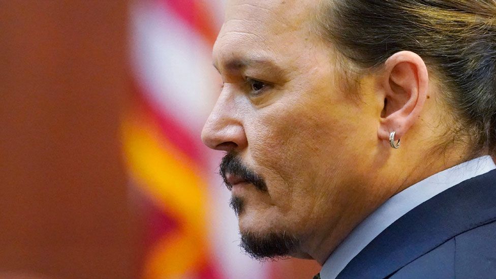 Actor Johnny Depp watches the jury arrive in the courtroom at the Fairfax County Circuit Courthouse in Fairfax, Virginia, on 23 May 23, 2022
