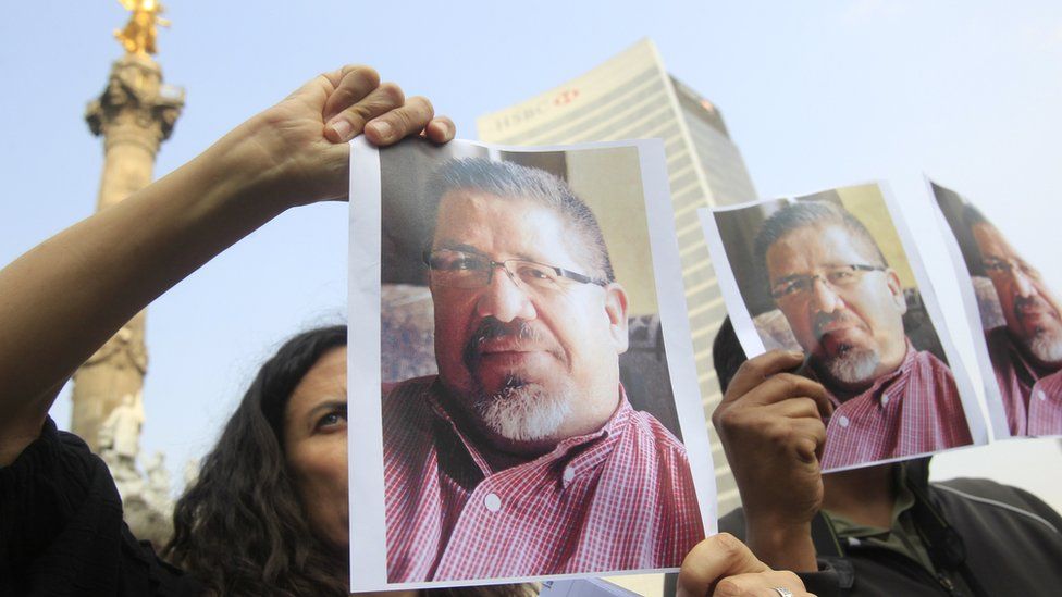 Journalists hold photos of slain Mexican journalist Javier Valdez in Mexico City, 16 May