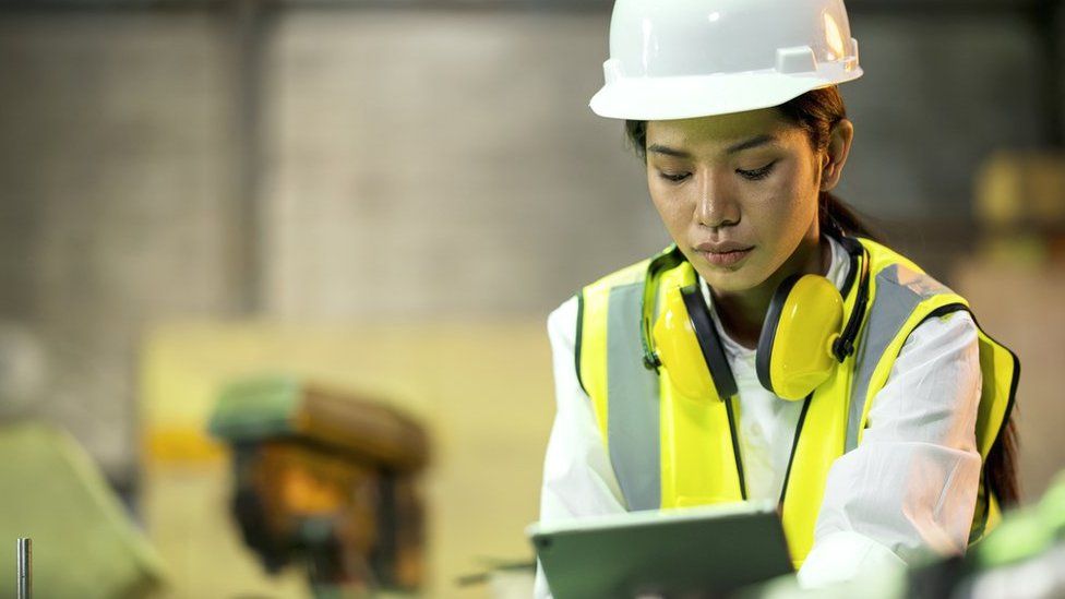 Woman using a tablet in a factory