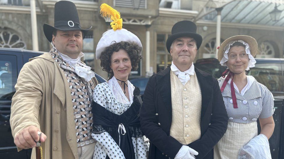 Four people in period dress