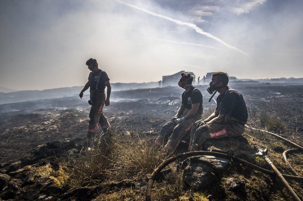 Fire fighters tackle the wildfire on Saddleworth Moor on 28 June 2018.