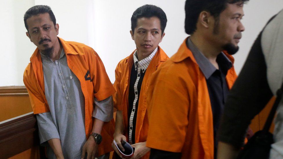 Suspected militants, from left, Abdul Hakim, Ahmad Junaedi and Tuah Febriwansyah, who is also known as Fachry, attend trial at West Jakarta District Court in Jakarta, Indonesia, Monday, Oct. 12, 2015