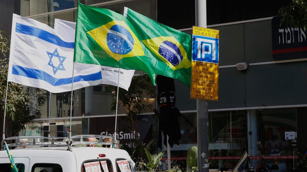 The Israeli and Brazilian flags hanging outside the building housing the offices of the Brazilian Embassy in Tel Aviv