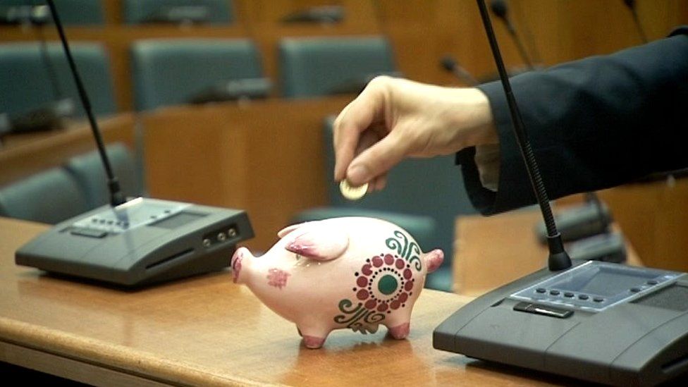 Piggy bank in a council chamber