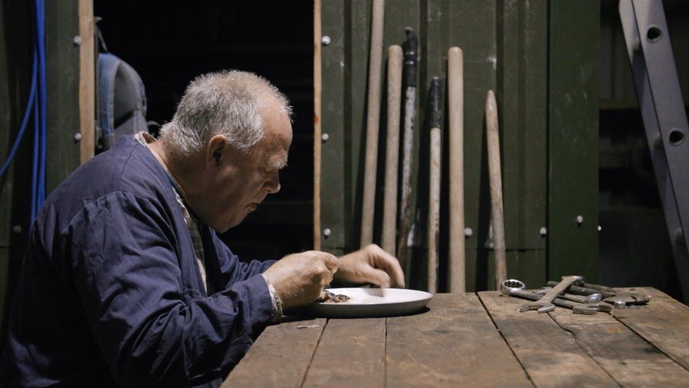 Still of Wilf Davies eating his dinner from Heart Valley