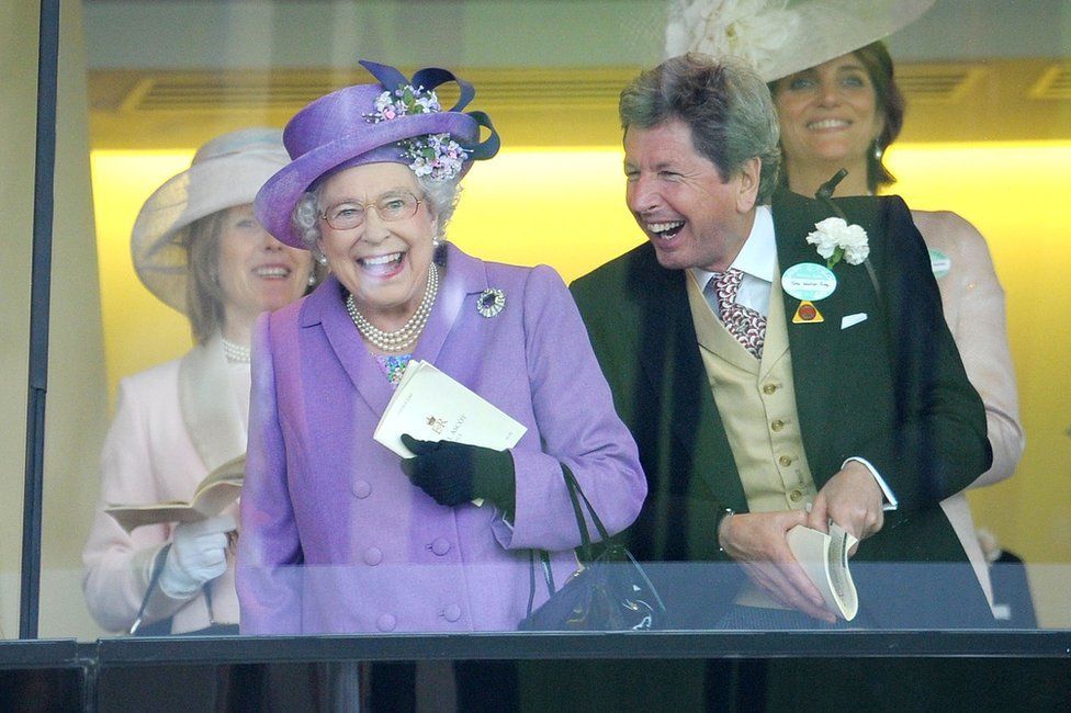 Britain's Queen Elizabeth II with her racing manager John Warren after her horse, Estimate, won the Gold Cup, 2013