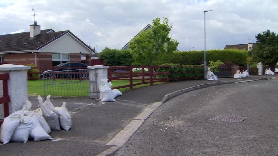 Sandbags sit outside houses after flooding