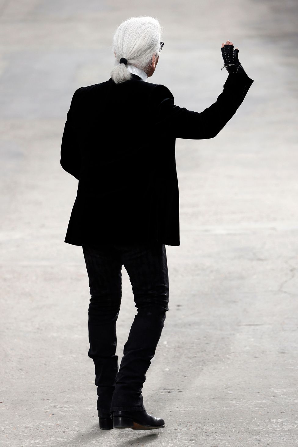 German fashion designer Karl Lagerfeld for Chanel acknowledges the public at the end of his 2014 Spring/Summer ready-to-wear collection fashion show at the Grand Palais in Paris.
