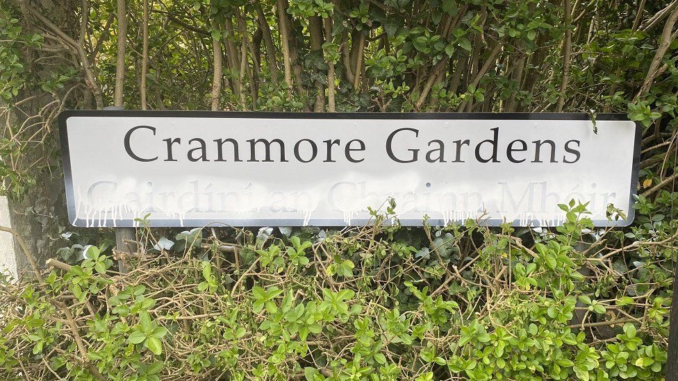 Cranmore gardens dual language sign spray painted