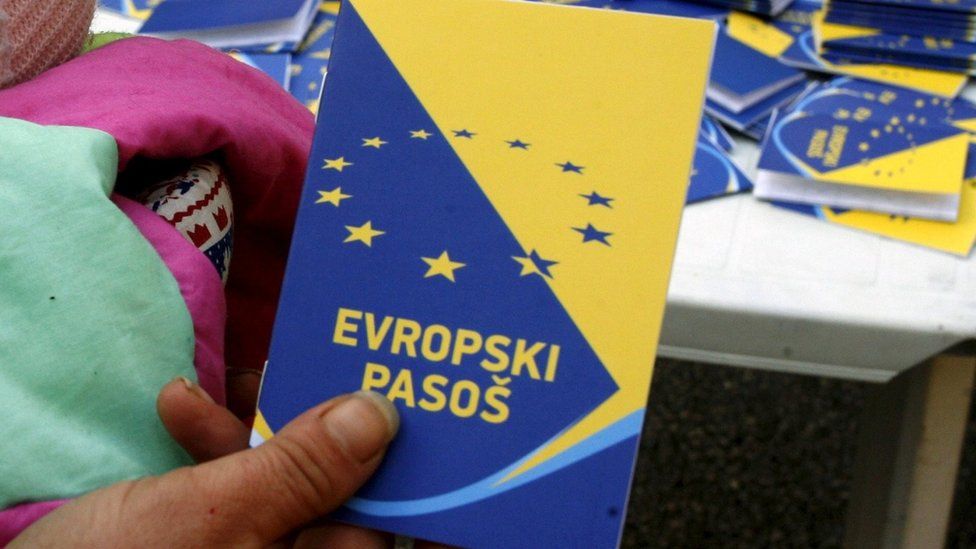 A volunteer holds up a mock European passport during a campaign by the Centre for Promotion of Civil Society in Sarajevo - 2010