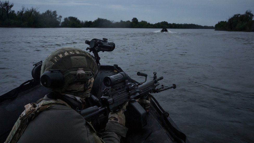 Ukrainian soldiers navigate on the Dnipro river by boat at the frontline near Kherson, Ukraine, Sunday, June 11, 2023.