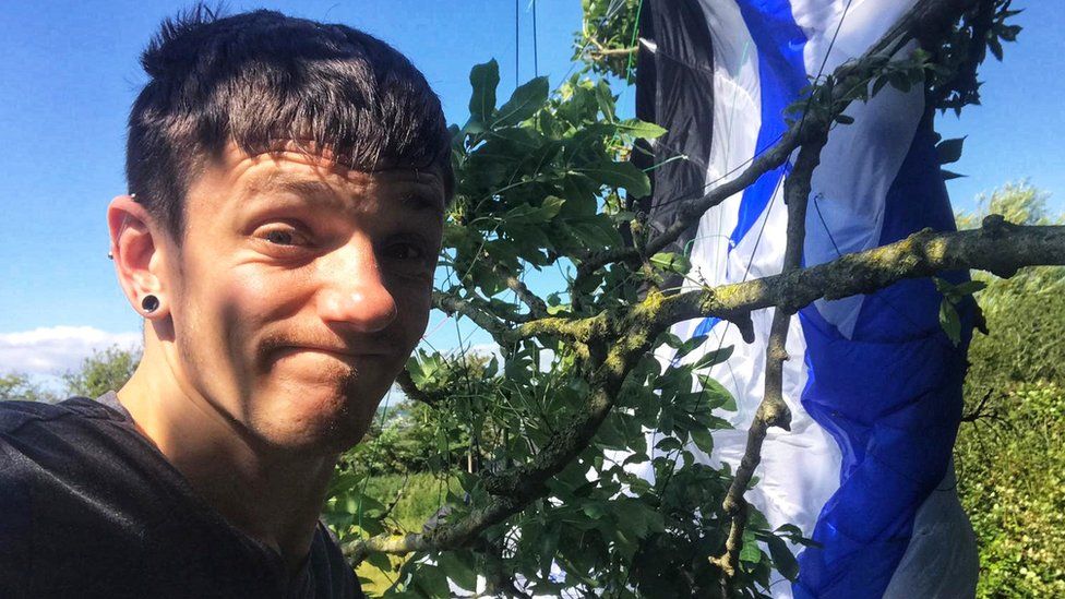 Daniel Jones with paramotor wing stuck in a tree after emergency landing