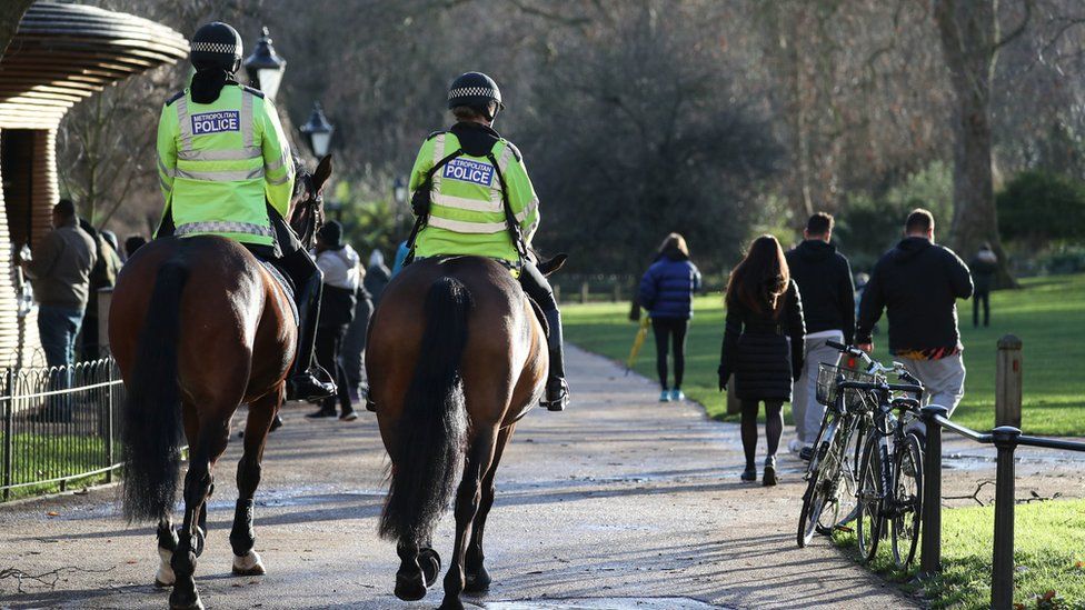 Police patrol on horseback through St James" Park in London. Millions more people moved to harsher coronavirus restrictions as the new tier changes came into force in England.