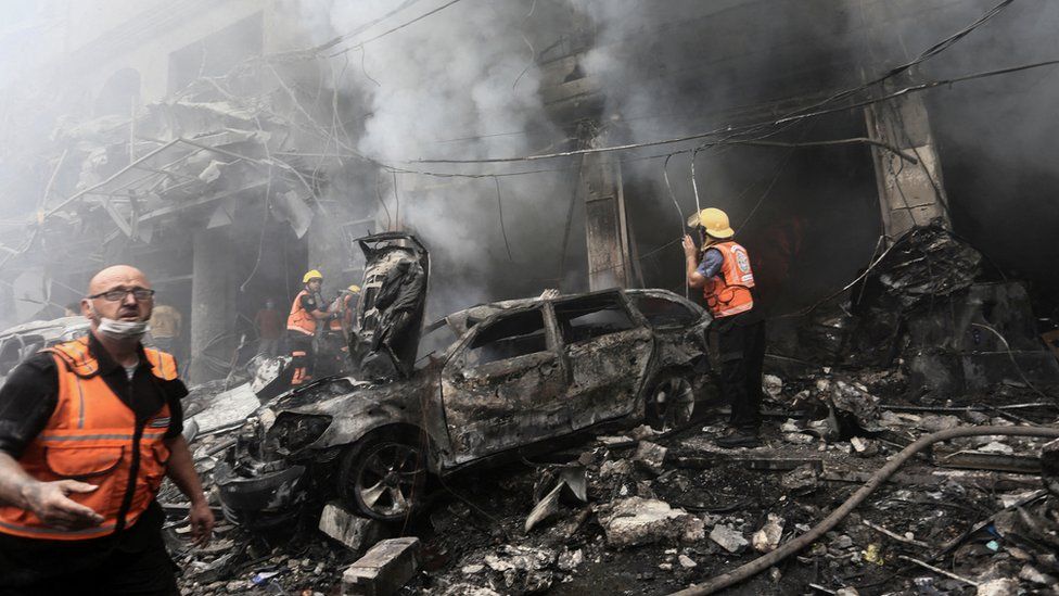 Palestinian first responders inspect the aftermath of a reported Israeli strike in Gaza City