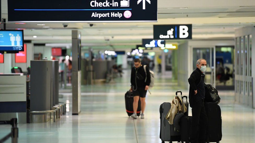 Travellers at Sydney Airport departure area on 20 March