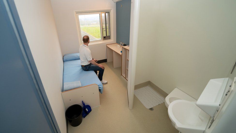 A prisoner sits in a cell at category C prison HMP Five Wells in Wellingborough