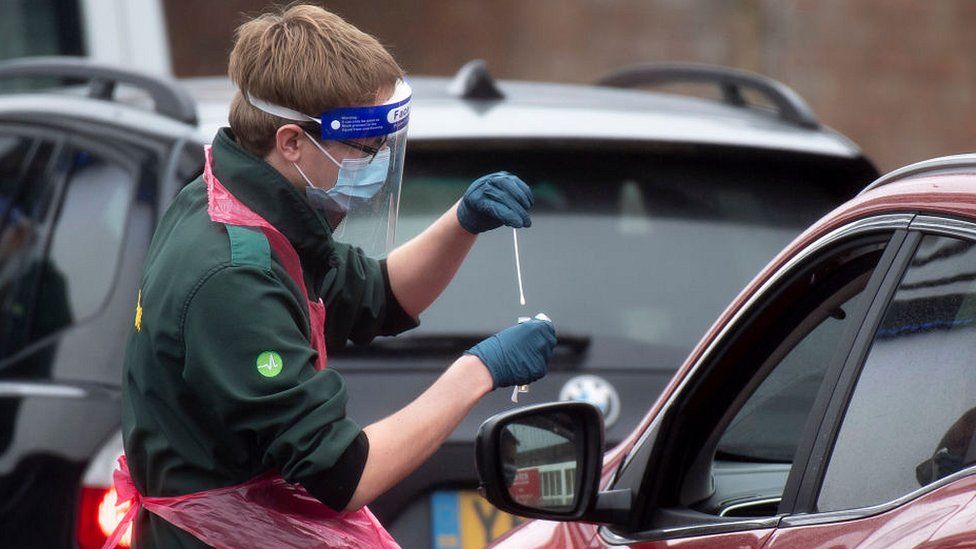 health worker taking swab through car window