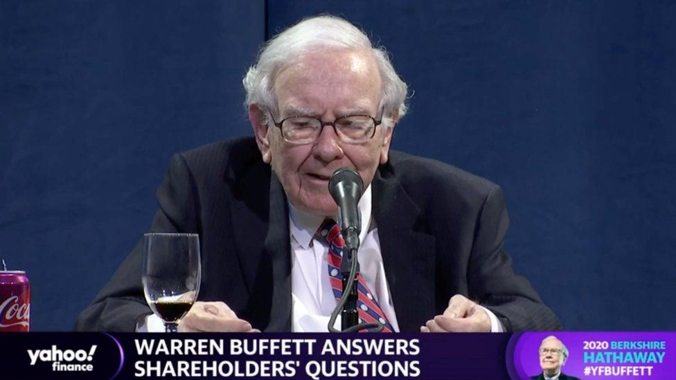 A screenshot of Warren Buffett speaking at the shareholders' meeting