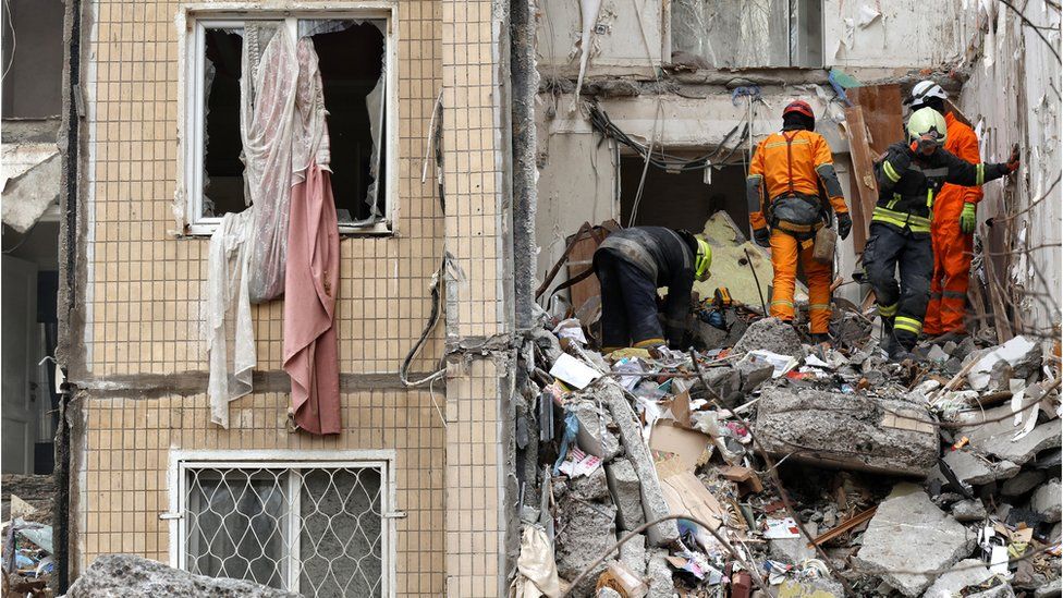 Rescuers remove rubble at a residential building destroyed by a Russian drone in Odesa, on 2 March 2024.