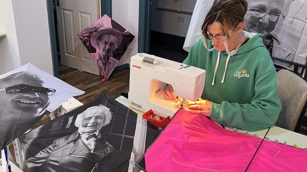 Kites being made using people's portraits