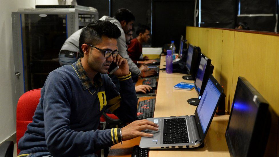 In this photograph taken on December 13, 2016, an employee of Indian IT security solutions company Innefu Labs works at their offices in New Delhi