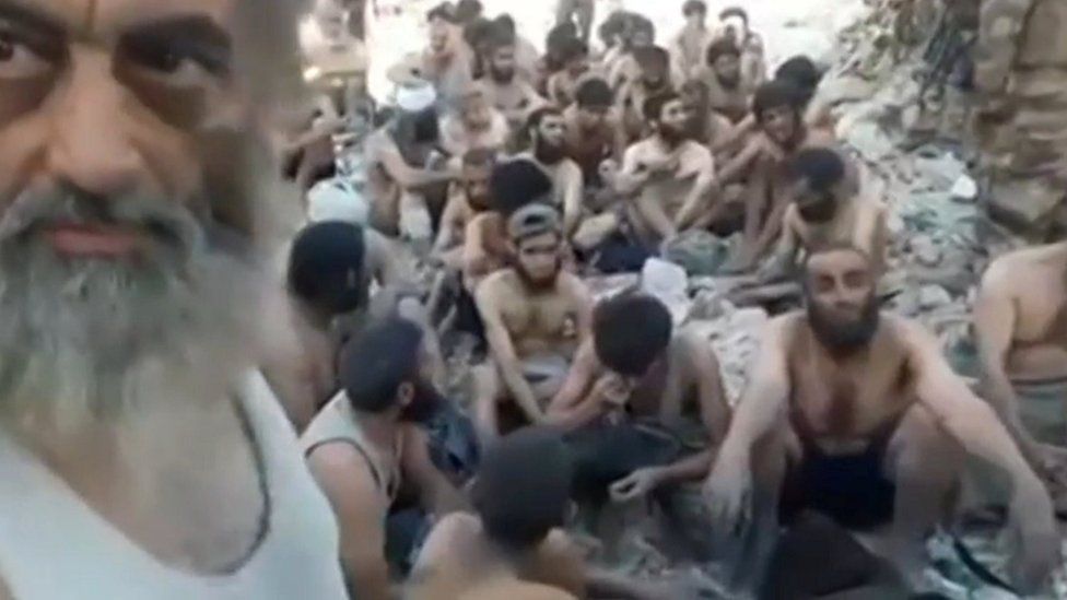 Still image taken from a video showing Islamic State militants surrender in the Old City of Mosul, Iraq (13 July 2017)