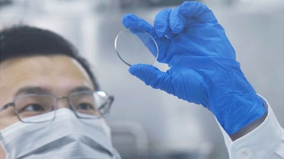 A researcher looks at a gallium oxide wafer at Zhejiang University Hangzhou International Science and Innovation Center in Hangzhou, Zhejiang Province, China.