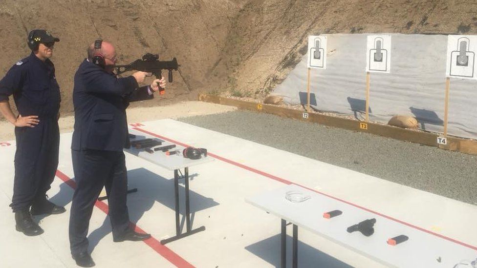 New South Wales Police Minister David Elliott shooting at a target with a submachine gun at a prison's rifle range