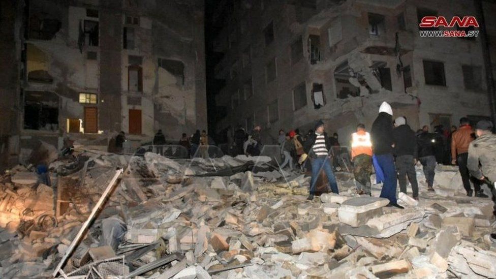 People search for survivors after a building collapsed in Hama, Syria. Photo: 6 February 2023