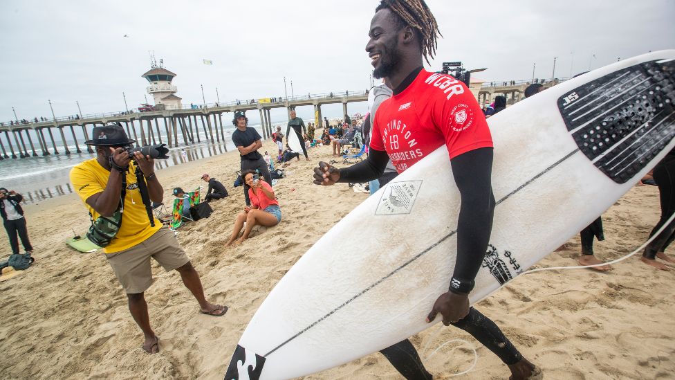 People cheering surfer Cherif Fall on a beach in California, the US - Saturday 4 June 2022