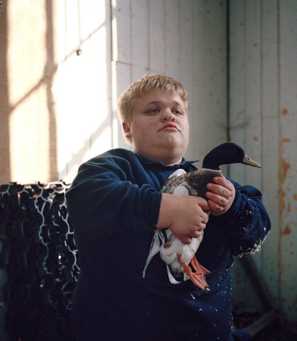 A boy holding a duck