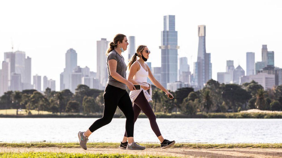 People are seen exercising at Albert Park Lake on 2 June 2024 in Melbourne, Australia