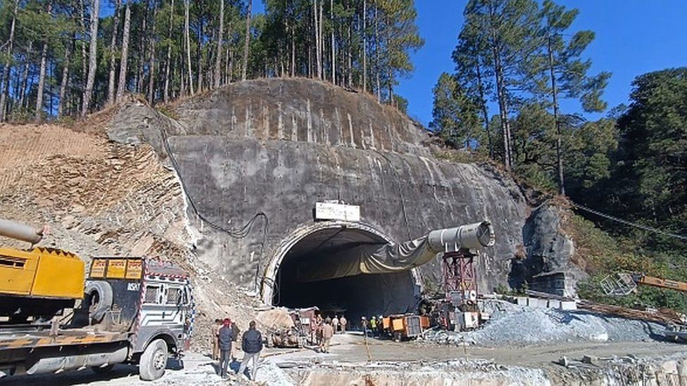 Rescue workers gather near the site after a tunnel collapsed in the Uttarkashi district of Uttarakhand state on November 13, 2023.