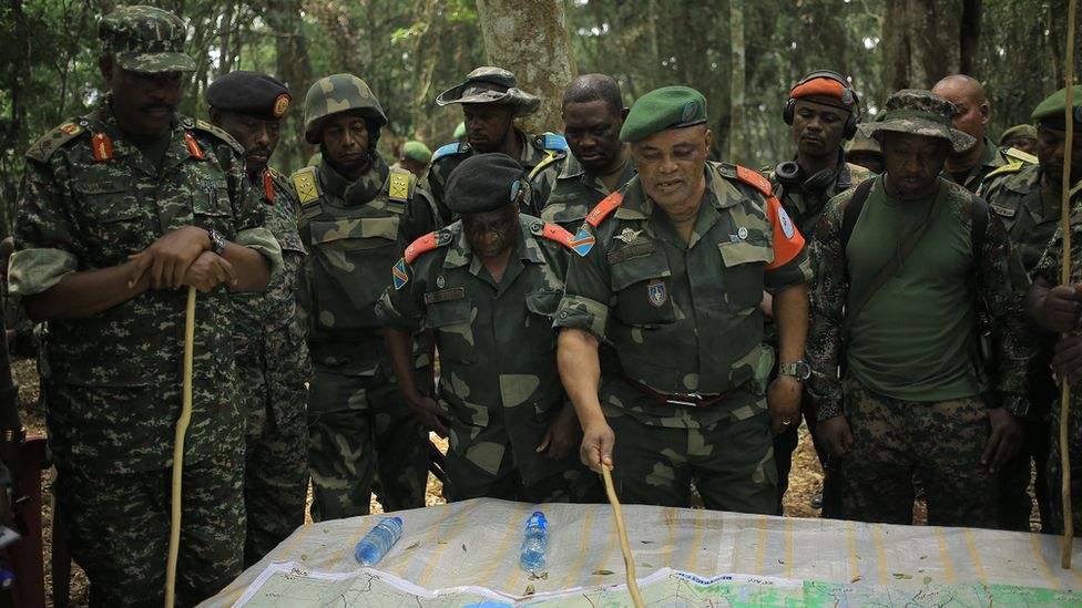Major General Camille Bombele, coordinator of the Joint Armed Forces of the Democratic Republic of Congo-Ugandan People's Defence Forces Military Operations talking with officers at the headquarters in the Virunga National Park on 17 December 2021