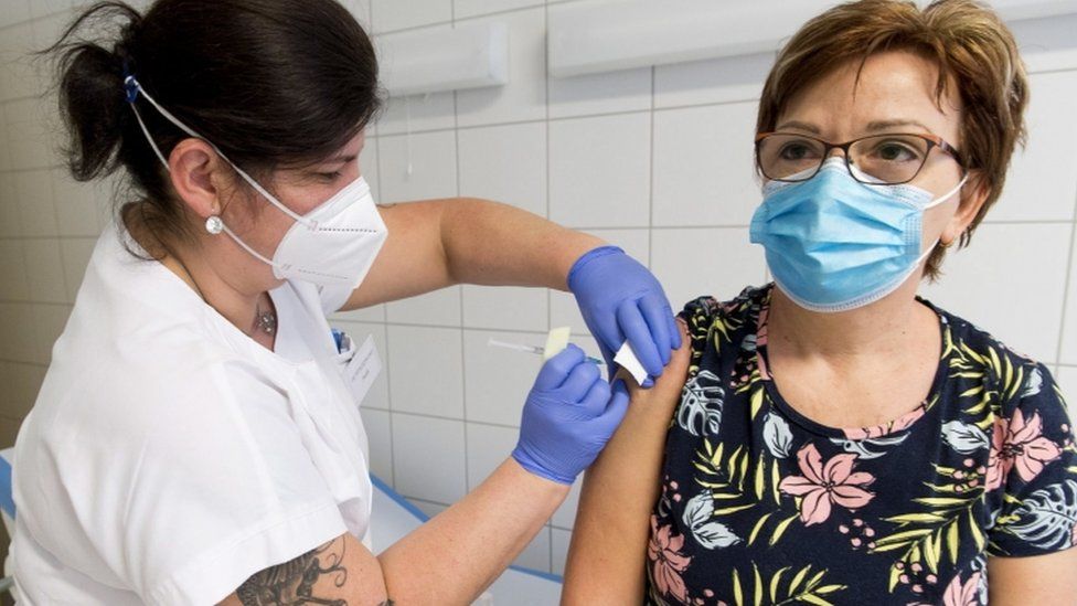 A healthcare worker receives the first dose of the Pfizer-Biontech's vaccine at the Petz Aladar Teaching Hospital in Gyor, Hungary