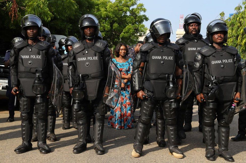 Abena Osei Asare, Deputy Minister of Finance, is protected by the police at the Ministry of Finance on the second day of a demonstration over soaring living costs in Accra, Ghana, on June 29, 2022
