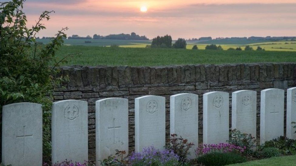 The sun sets over headstones at the Hawthorn Ridge Cemetery, France