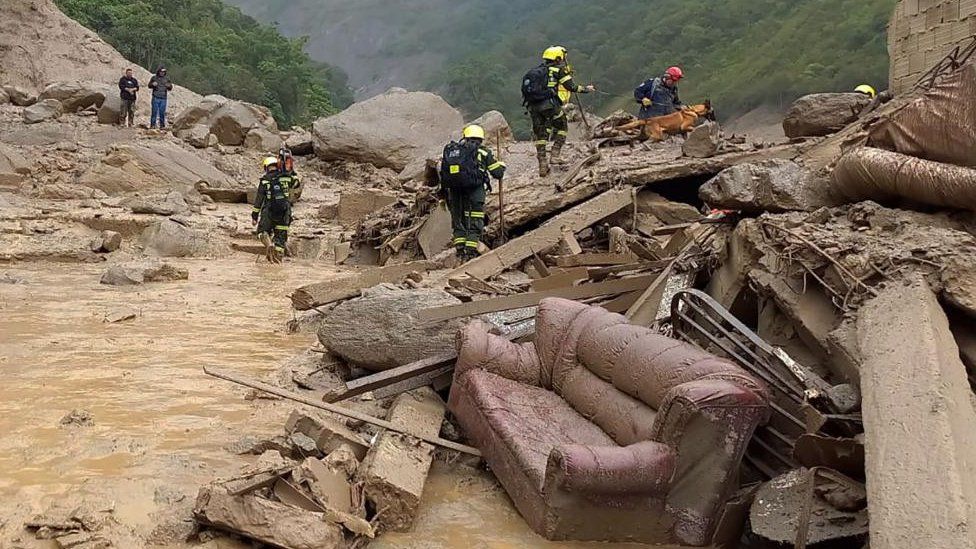 A handout photo made available by the Colombian National Police shows members of search and rescue teams search for survivors after landslide in Quetame, Cundinamarca, Colombia, 18 July 2023