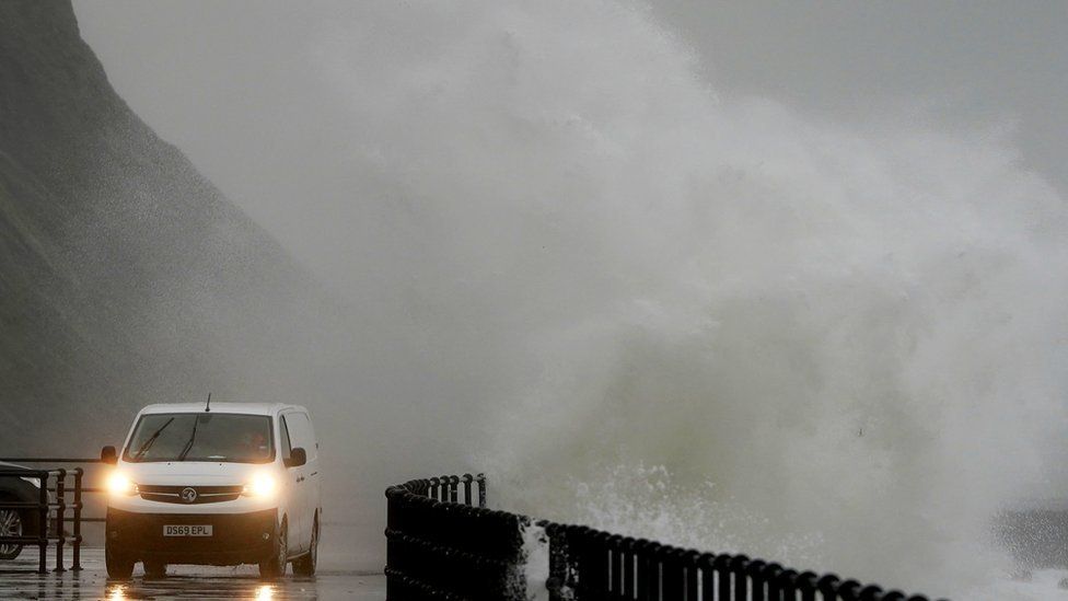 Waves crash over the promenade during rain and strong winds in Folkestone, Kent