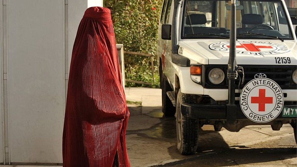 File photo of pedestrian passing vehicle at the International Committee for the Red Cross (ICRC) office in Kabul.