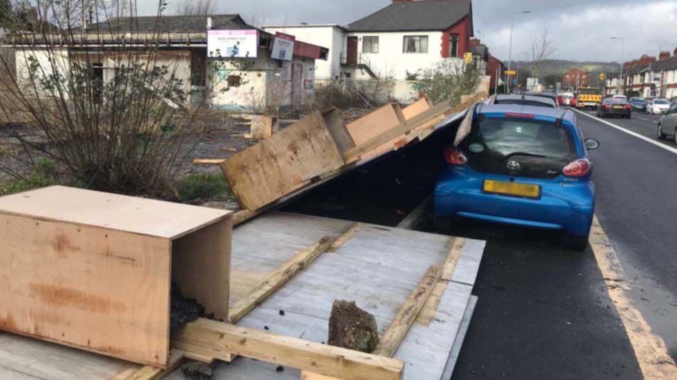 A fence falls onto a car in the Birchgrove area of Cardiff