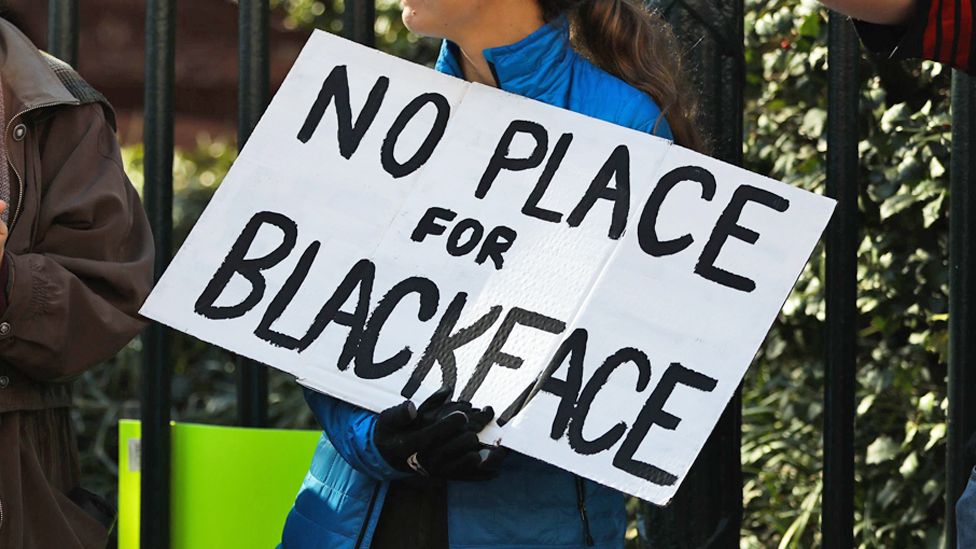 Sign pictured reads: NO PLACE FOR BLACKFACE