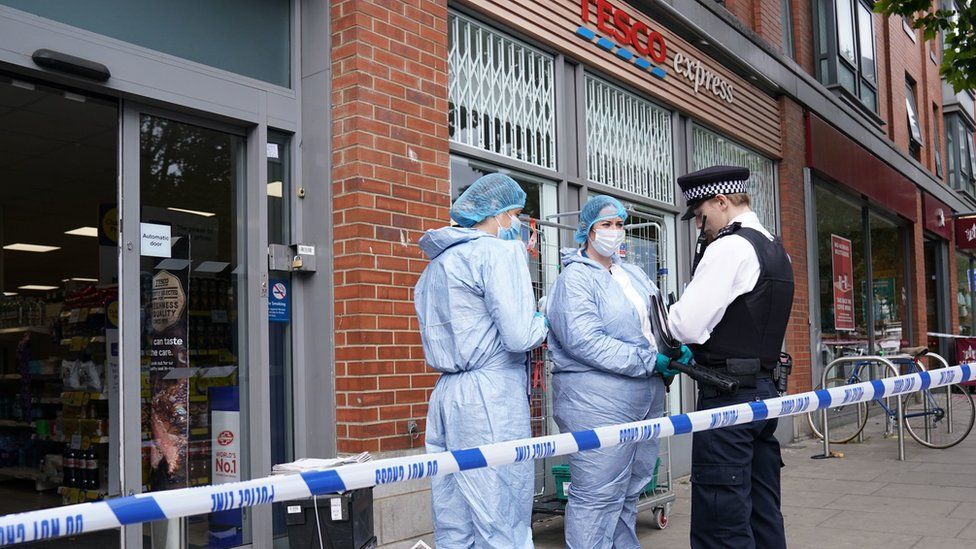 Police outside Tesco Express in Fulham after the alleged incidents