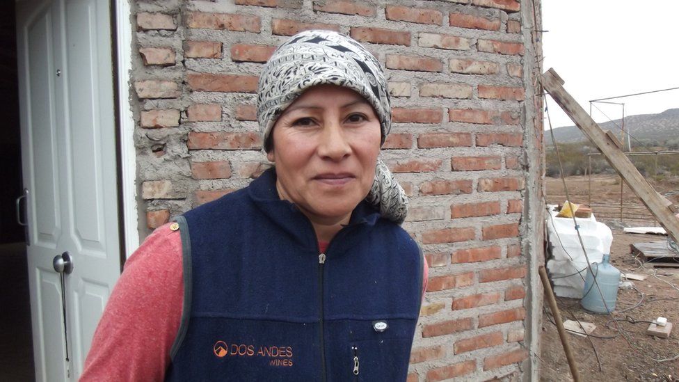 Susana Campo in front of her home