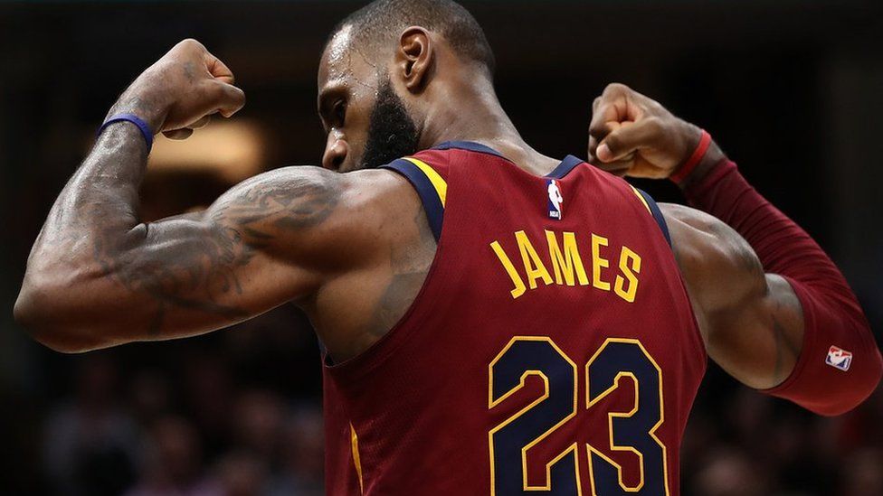 LeBron James of the Cleveland Cavaliers shows off his biceps after scoring a basket